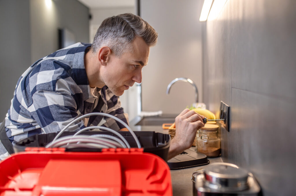 electrician installing outlet in the kitchen