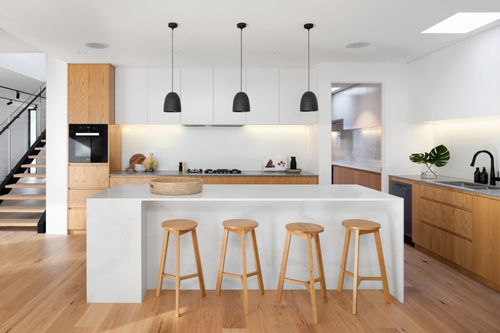 A stylish kitchen island equipped with compliant and conveniently placed electrical outlets, illustrating adherence to NEC guidelines